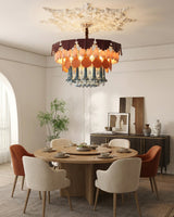Dining room with a round table and chairs, featuring a modern chandelier.