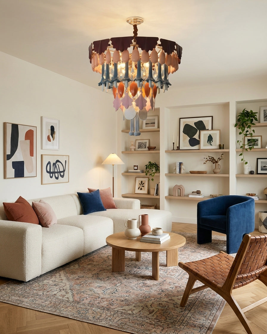 Living room with a chandelier, sofa, coffee table, and bookshelf.