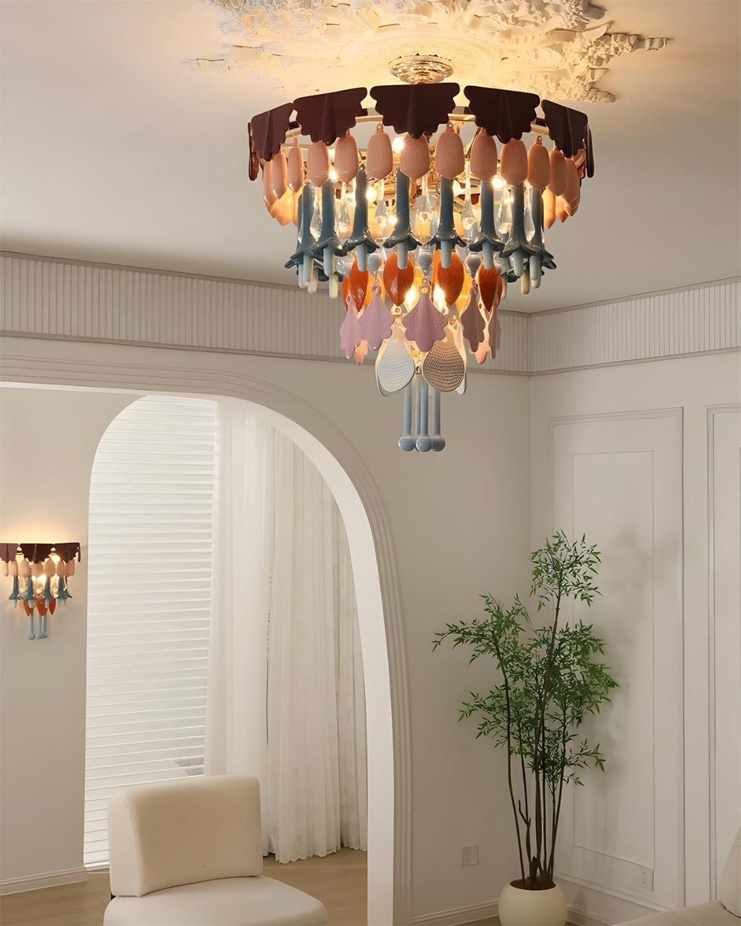 Chandelier hanging in a room with a plant and chair
