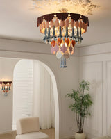 Chandelier hanging in a room with a plant and chair