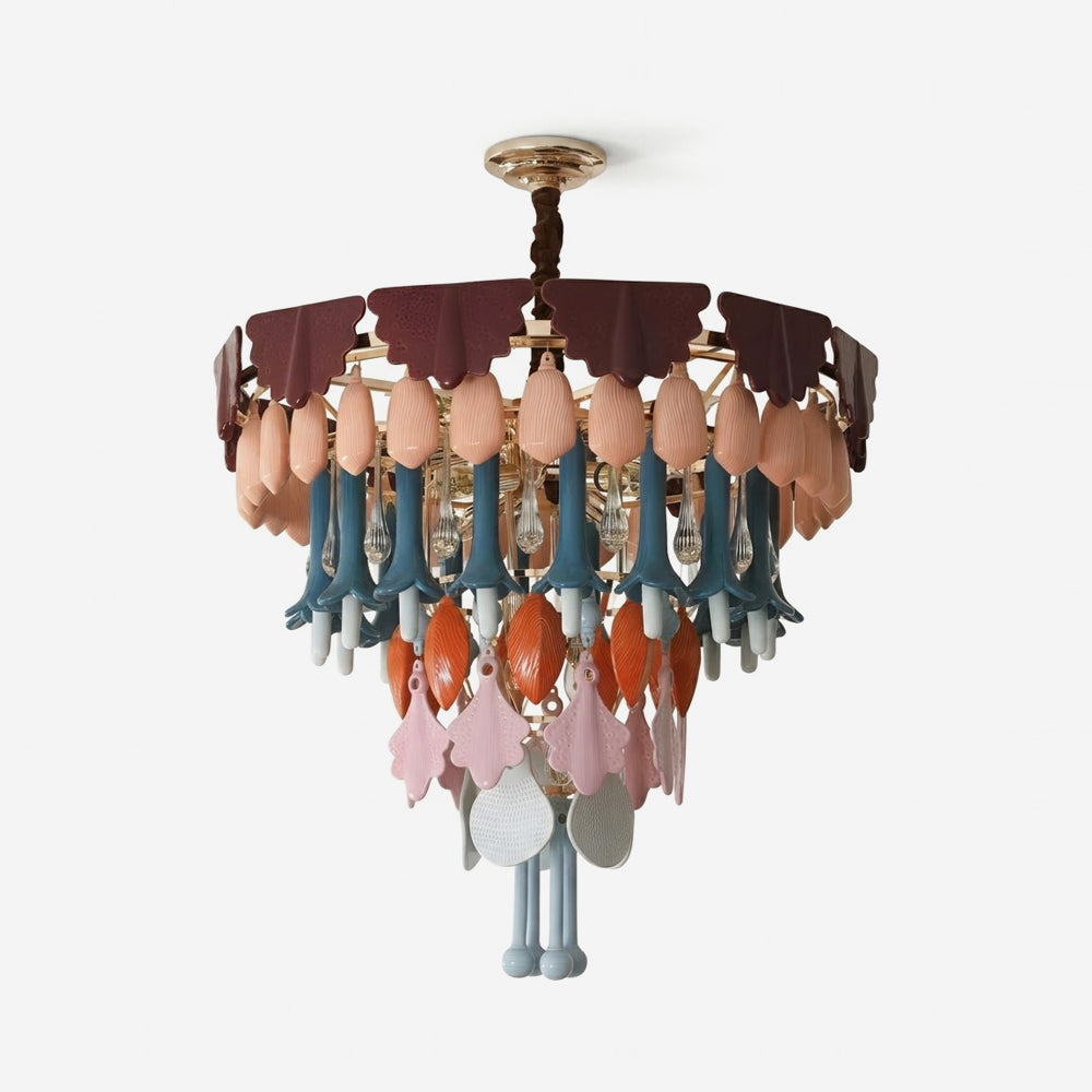 A multicolor decorative chandelier with a gold-toned metal frame, featuring layered tiers of scalloped dark burgundy and dusty rose shades, peach-colored teardrop ornaments, teal and orange hanging accents, and pink and gray leaf-shaped ornaments, shown against a plain white background.