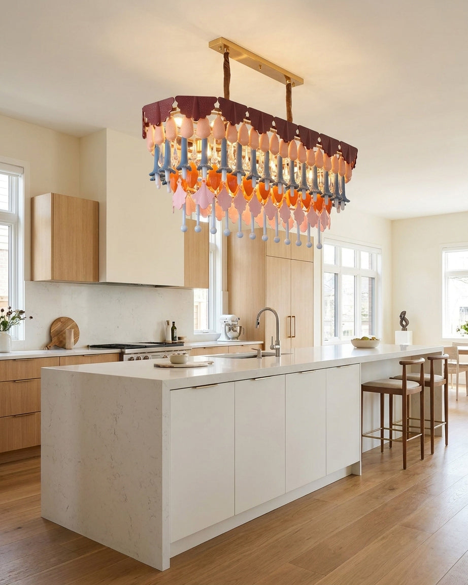 Modern kitchen with a chandelier hanging above a kitchen island.