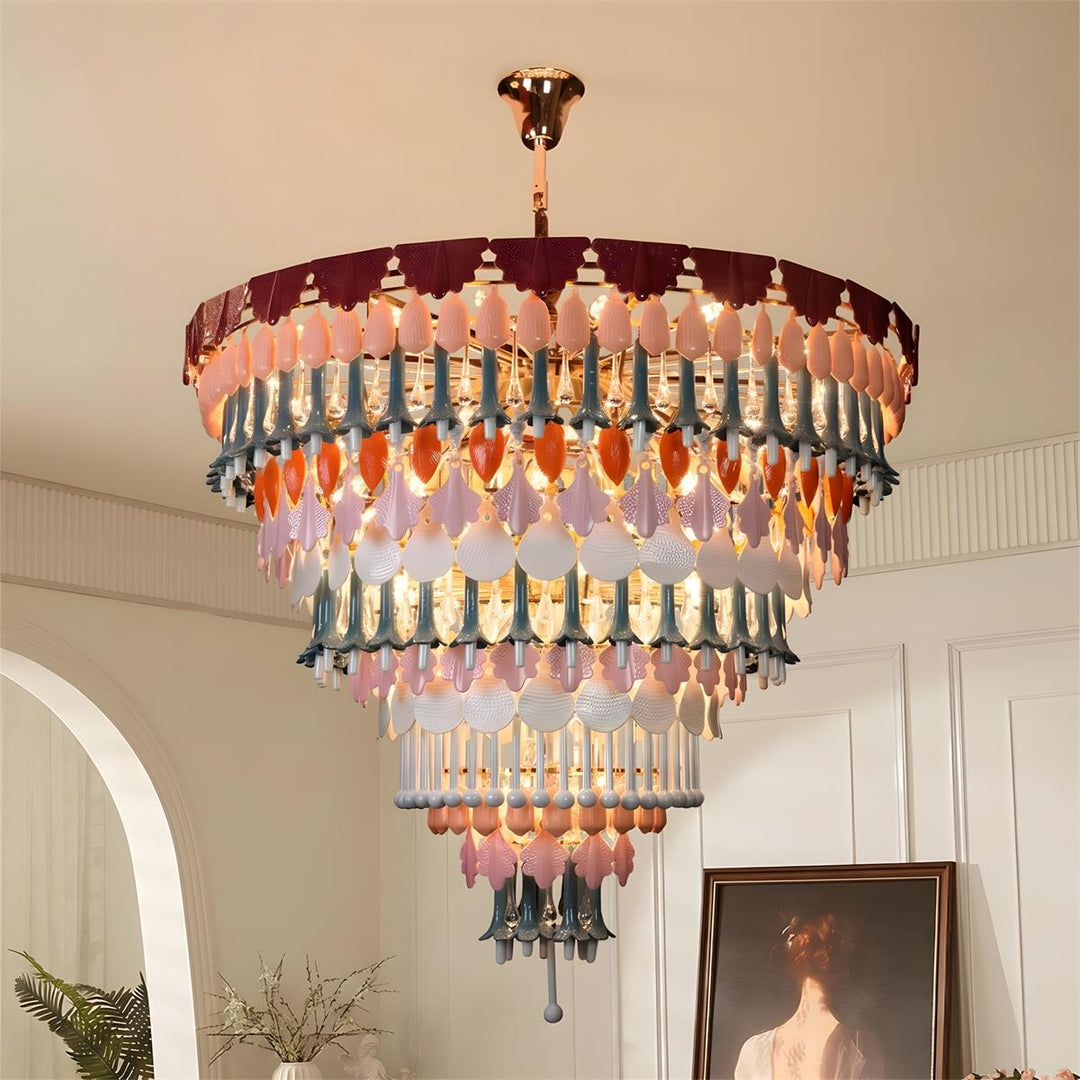 Multicolored chandelier hanging in a room with a painting and plant.