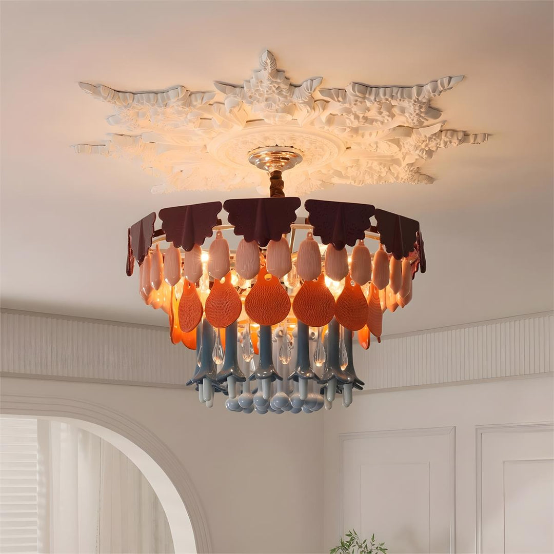 Illuminated multicolor chandelier hangs beneath an ornate white ceiling rose in a room with paneled walls and an arched opening.