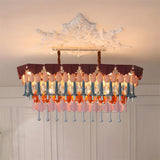 Decorative chandelier with colorful glass shades on a neutral background