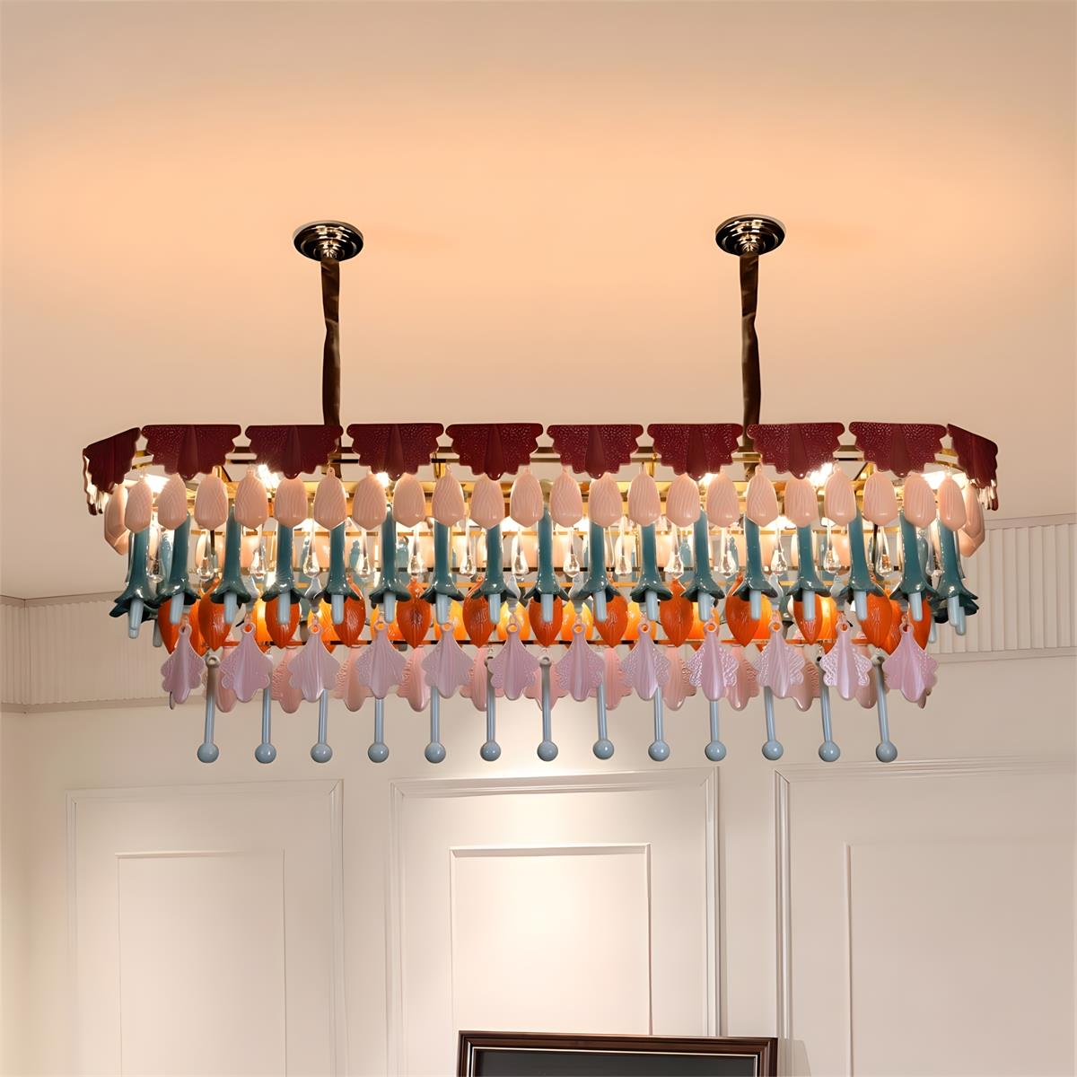 Colorful chandelier hanging in a room with white walls and a staircase.