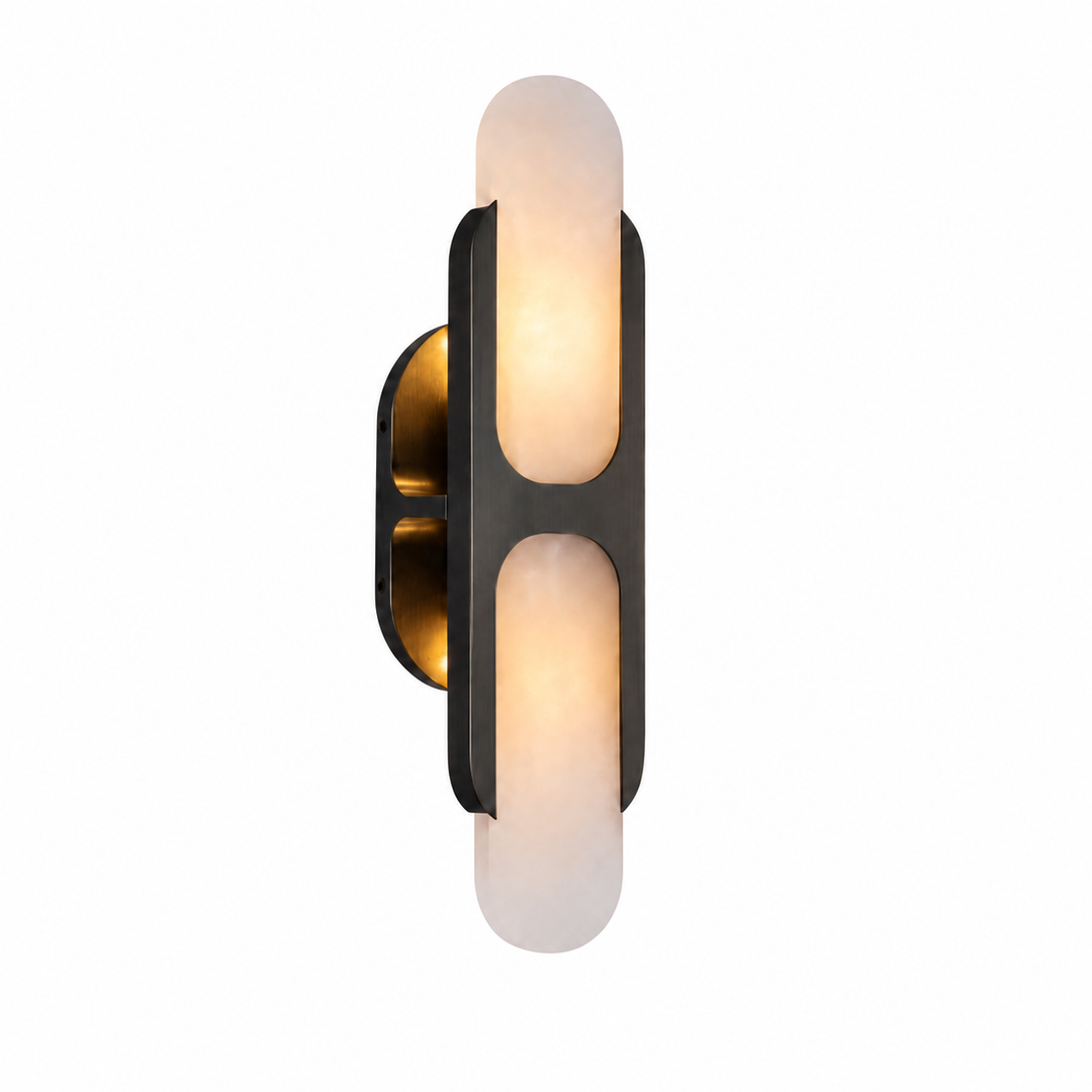 Wall sconce with dark metal frame and two frosted white glowing shades on a plain white background