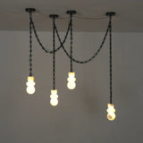 Front view of a chandelier with four illuminated cream alabaster shades and looping black chains against a plain gray wall.