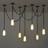 A multi-light pendant chandelier with black metal chains and spherical glass shades, shown hanging against a plain light gray wall.