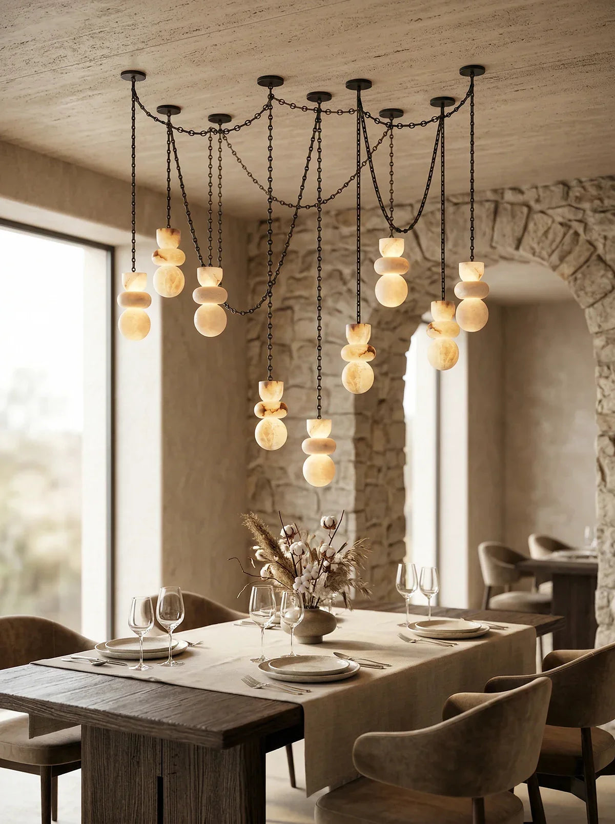 Dining room with a modern chandelier, wooden table, and chairs.