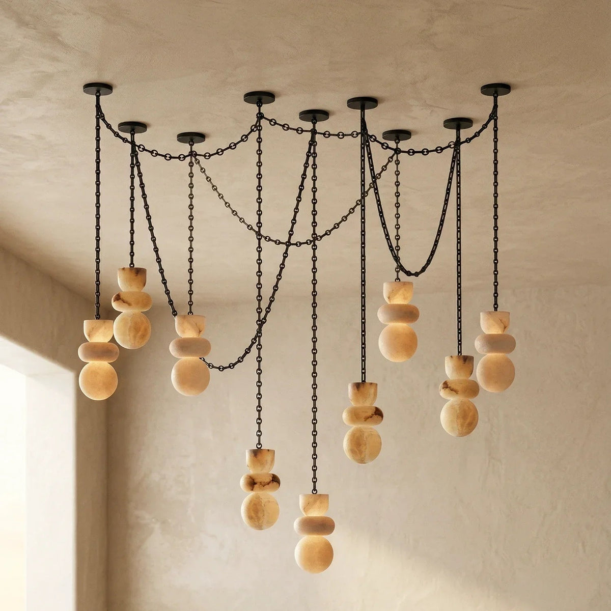 Chandelier with wooden beads and black chains on a beige wall.