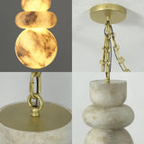 A four-panel close-up of a hanging chandelier or pendant light with stacked oval stone shades in warm cream and beige marbled tones, paired with brushed gold/brass hardware and chain suspension.