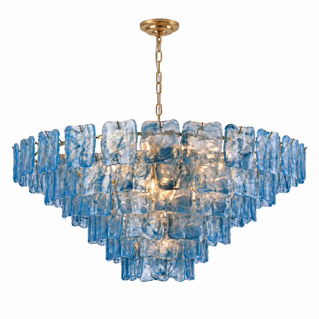 Illuminated chandelier with tiered blue textured glass panels and a gold chain and ceiling canopy against a white background.