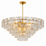 Illuminated chandelier with tiered clear textured glass panels and a gold chain against a white background.