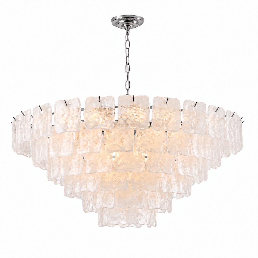 A modern multi-tier chandelier with textured, translucent clear glass square shades and a polished silver-tone metal canopy and chain, shown against a plain white background.