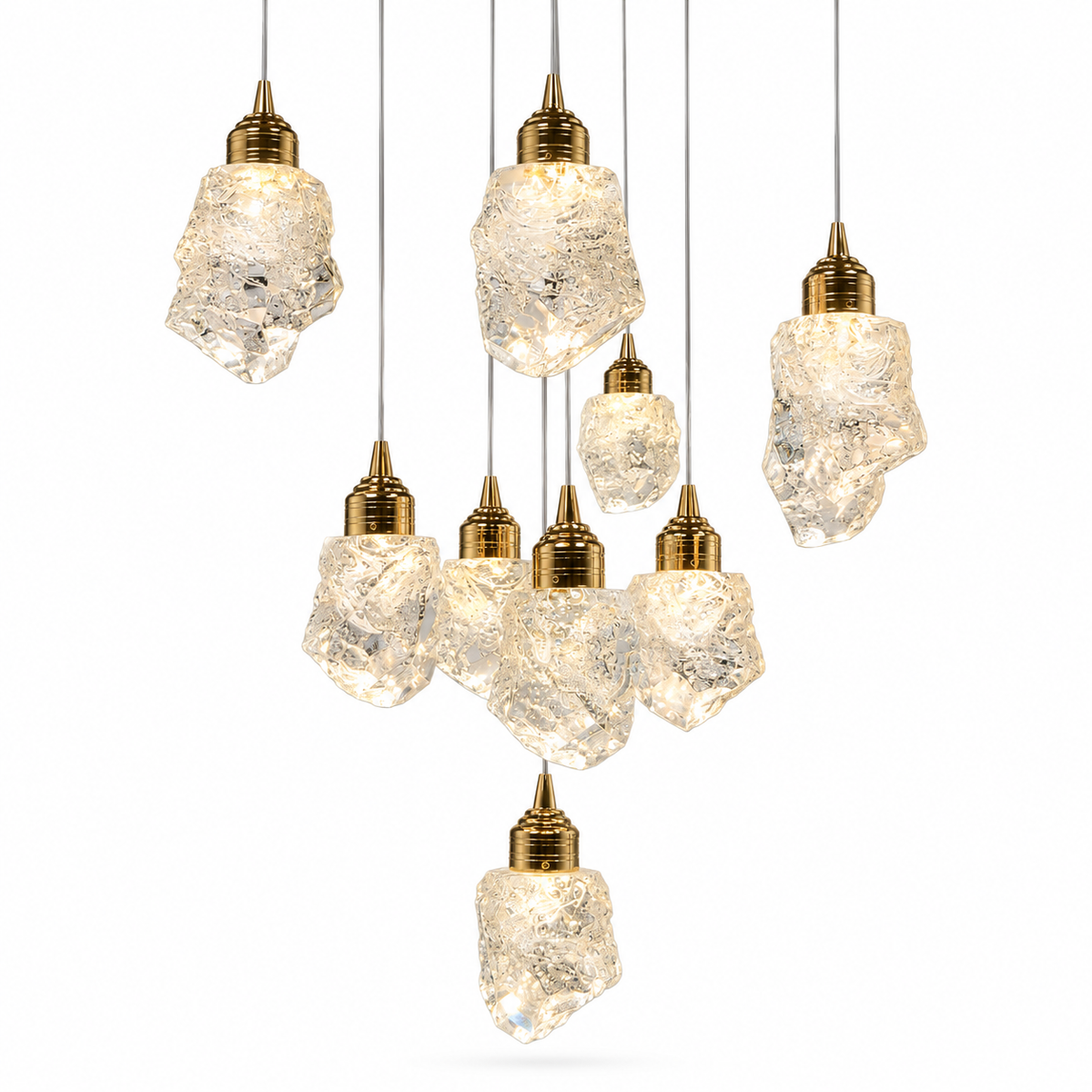 A chandelier with nine illuminated, ice-shaped clear crystal shades and gold fittings hangs at staggered heights against a white background.