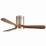 A modern three-blade ceiling fan with a brushed nickel metal motor housing and warm brown wood blades, featuring an integrated round light fixture below, shown against a plain white background.