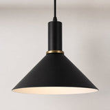 A modern black metal pendant light with a wide conical shade, a brass ring accent, and a warm glowing interior, suspended against a neutral light gray background.