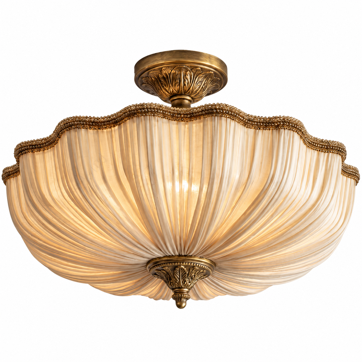 A semi-flush mount ceiling light fixture featuring a warm, cream-colored pleated glass shade and ornate antique brass metal hardware.
