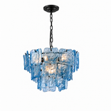 A modern multi-light chandelier featuring textured, irregularly shaped blue glass shades suspended from a black metal chain and canopy against a solid white background.