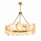A modern multi-light chandelier featuring circular white agate or onyx flower-like shades with natural marbling, suspended by gold-toned brass rods and chain against a solid white background.