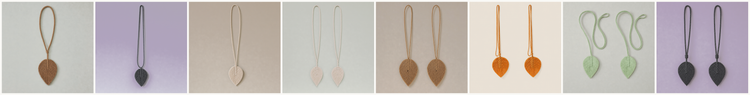 A horizontal strip of ten small product photos showing long narrow necklaces with heart-shaped pendants in various colors, including brown, black, white, pink, tan, orange, green, and dark gray, each displayed against a plain light background.