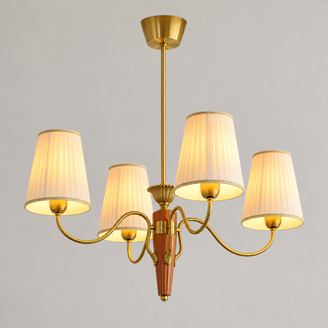 A five-light brass chandelier with pleated white fabric shades, shown illuminated against a neutral gray background.