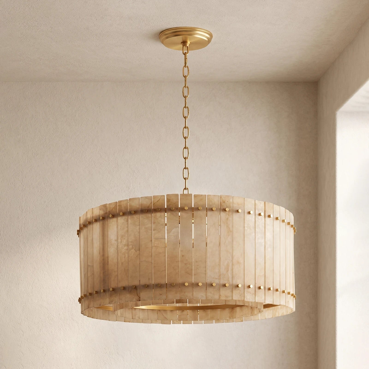 Round single-tier chandelier with cream alabaster panels, brass bands, and a matching chain hangs against beige walls.