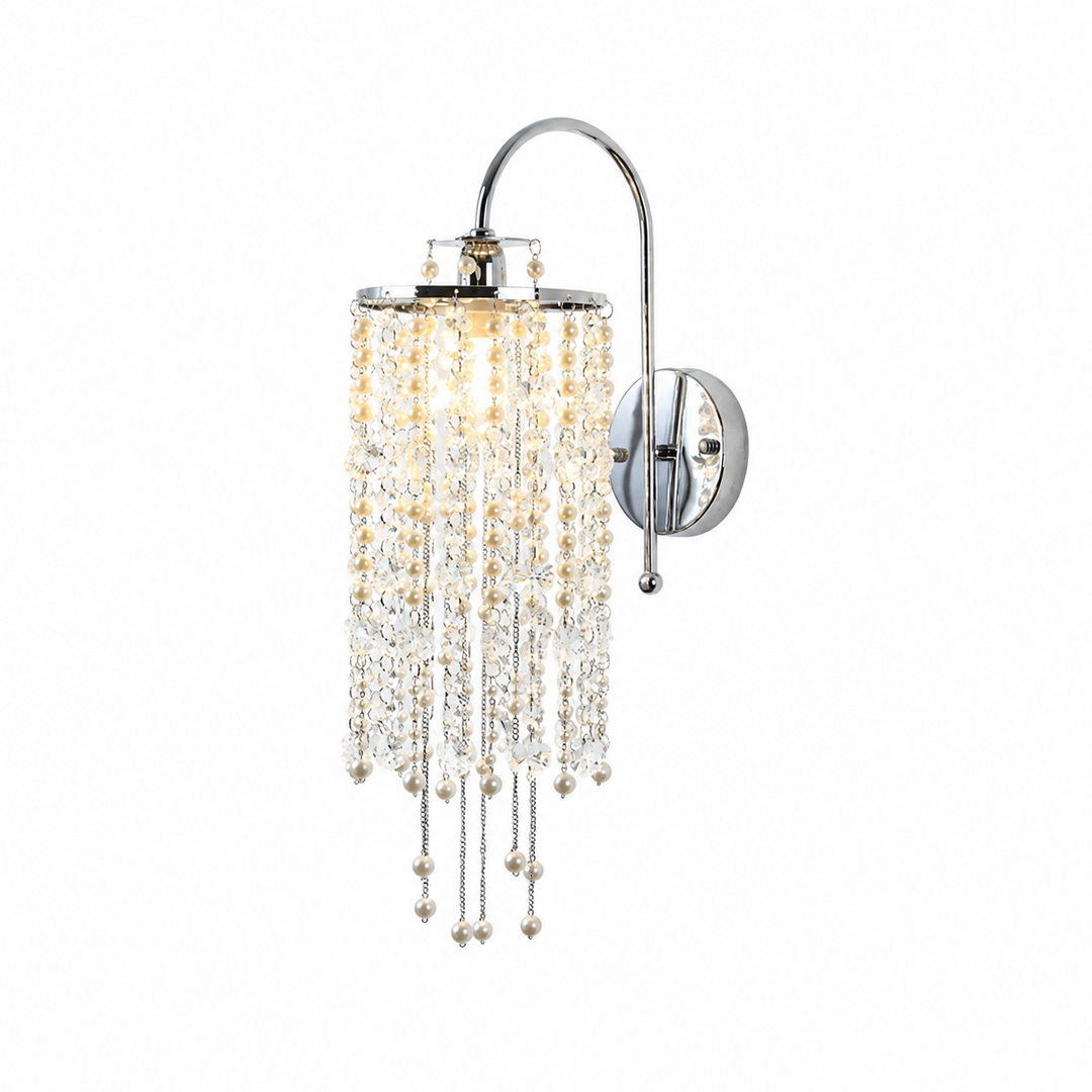 Silver wall sconce with a curved arm, cascading clear and pearl-like beads, and a warm glowing bulb against a white background.