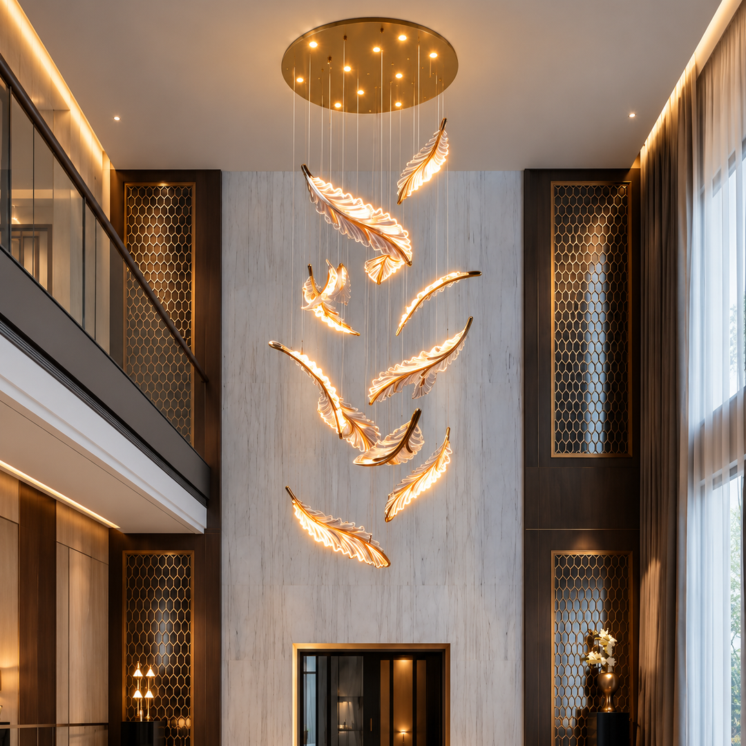 A modern multi-light feather chandelier with warm glowing feather-shaped bulbs suspended from a circular gold ceiling mount in a high-ceilinged interior hall.