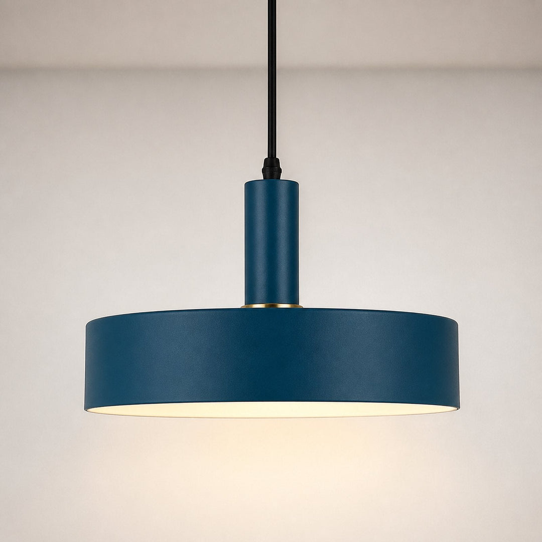 A modern pendant light with a matte navy blue cylindrical shade and a black hanging cord, shown against a neutral light gray background.