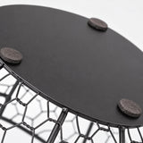 Flat non-slip pads beneath the black iron egg basket.