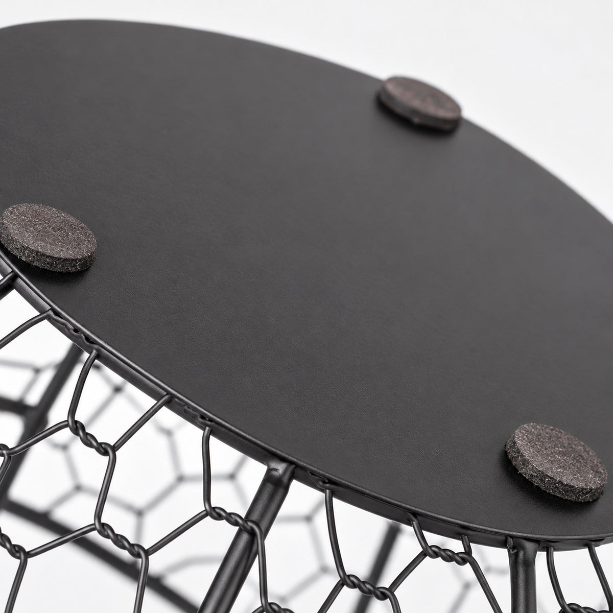Flat non-slip pads beneath the black iron egg basket.