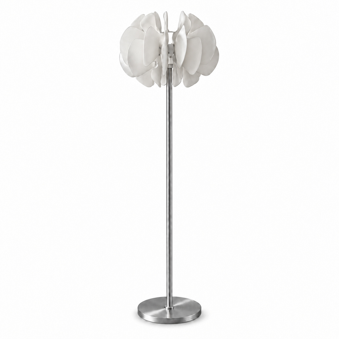A modern floor lamp with a brushed silver metal stand and a white flower-like shade made of layered petal shapes, shown against a plain white background.