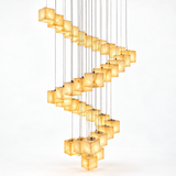 A modern spiral chandelier featuring multiple warm, glowing cube-shaped pendant lights suspended by thin vertical metal wires against a clean white background.