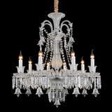 An ornate multi-light crystal chandelier with candle-style bulbs, hanging clear glass prisms, and a decorative woven rope detail at the top, shown against a solid black background.