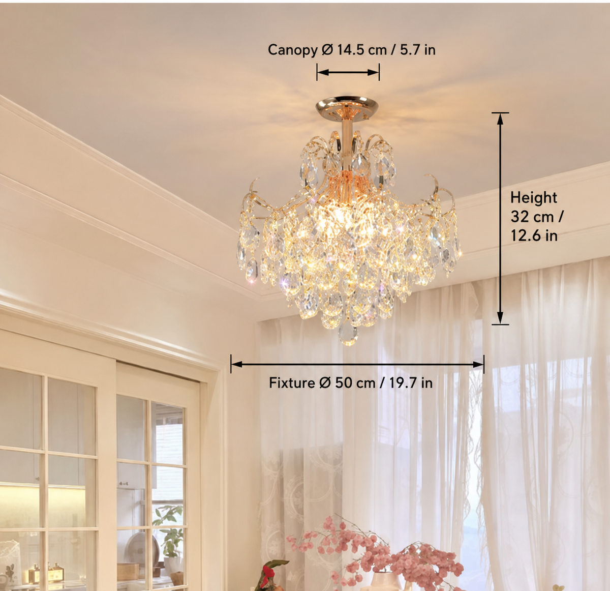 A crystal chandelier hanging in a bright room, with overlaid dimension labels showing canopy diameter 14.5 cm / 5.