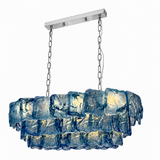 Linear chandelier with three tiers of textured blue glass, silver-toned chains and a matching ceiling canopy against a white background.