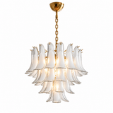 A modern multi-light chandelier with clear glass petal-shaped shades and a brushed gold metal canopy, chain, and arm details, shown against a solid white background.
