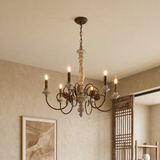 A rustic six-light chandelier with a weathered cream-colored central column and dark metal arms, hanging from a chain in a warm, neutral-toned room.