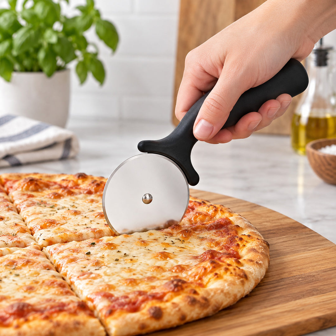 Black handled pizza wheel cutting a cheese pizza.