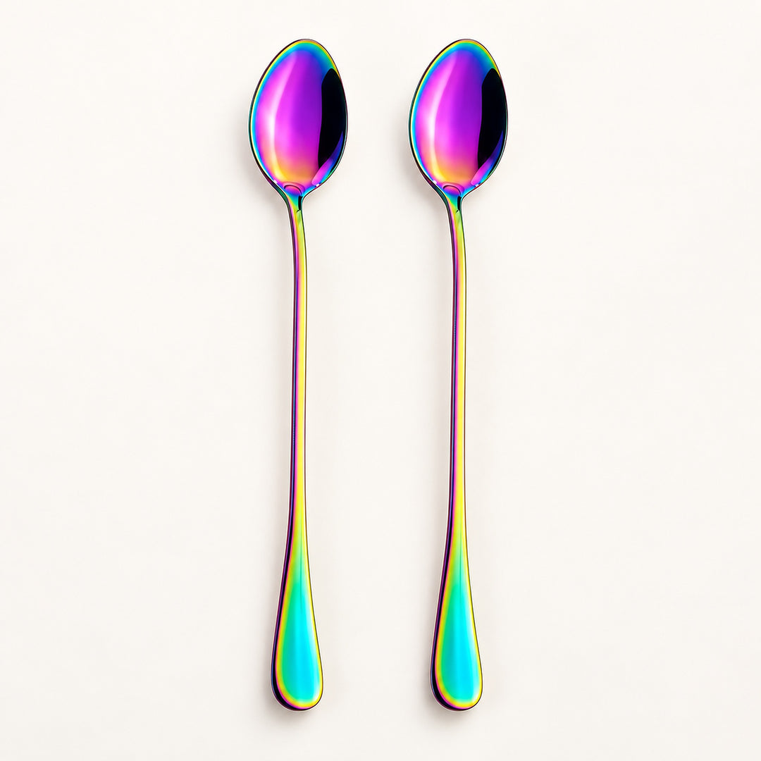 Two long spoons with an iridescent rainbow finish, standing upright against a clean off-white background.