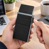 Hand using the side lever of a gray and black card wallet to access sample cards.