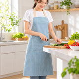 Blue striped bib apron worn while preparing vegetables in a kitchen.