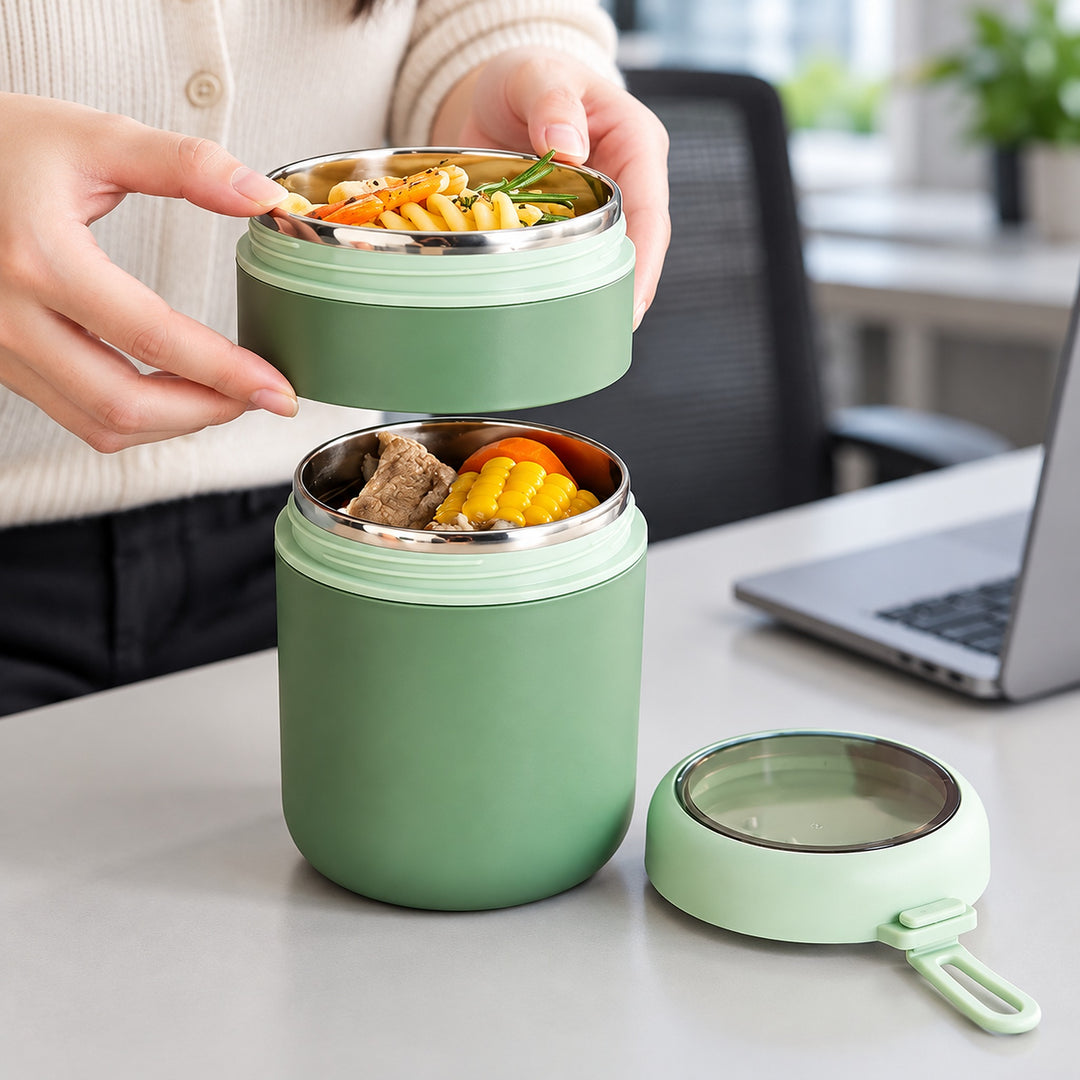 Green food jar used to serve lunch from its two compartments.