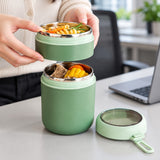 Green food jar used to serve lunch from its two compartments.