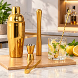Stainless steel cocktail shaker kit organized on a home bar counter