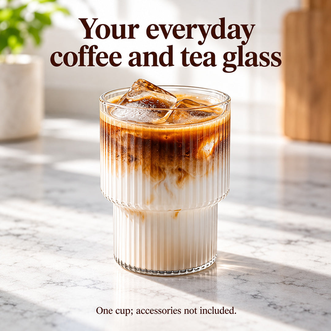 Clear ribbed stepped-base glass serving iced latte; one cup, accessories not included.