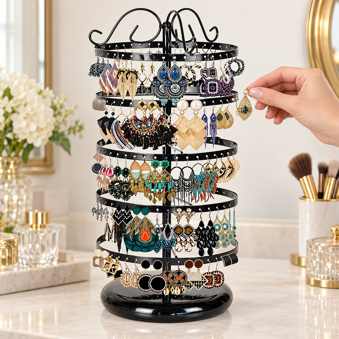 Choosing earrings from a black five-tier round-base stand.