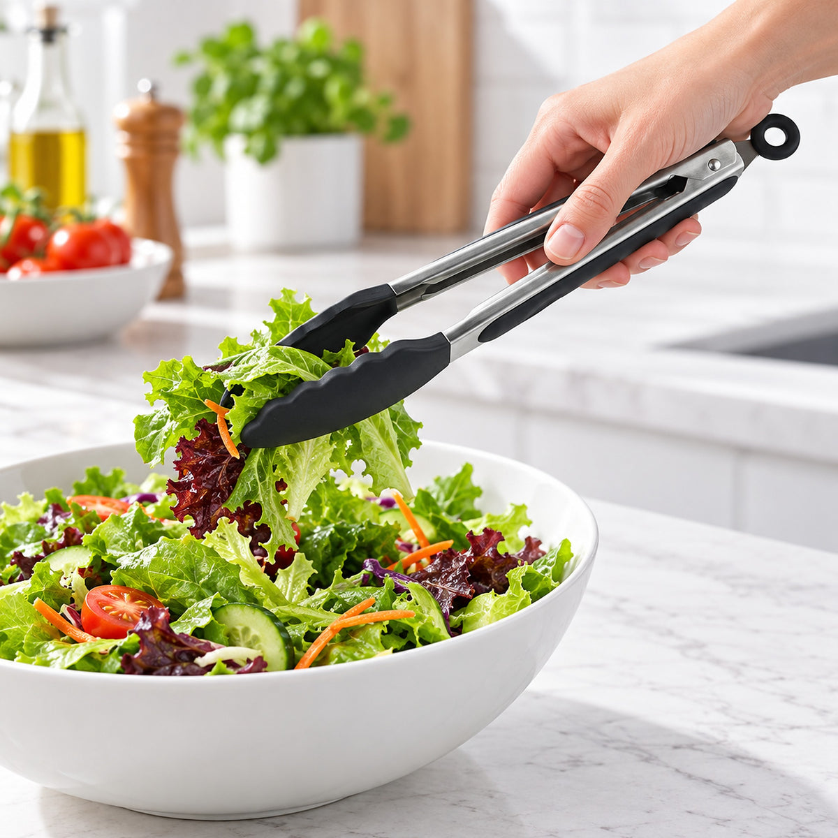 Black silicone-tipped tongs lifting salad, 9 in.